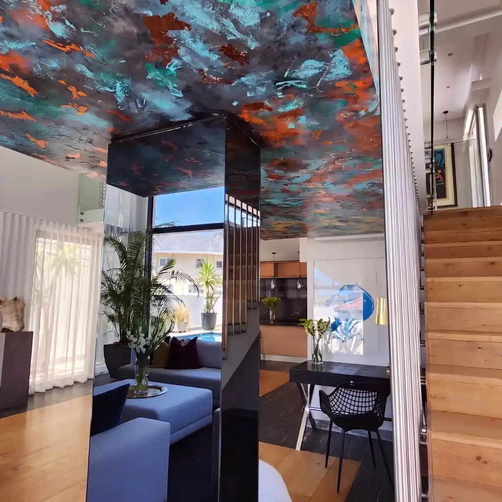 Reconstruction from a photograph: a ceiling above a stair hall in Bantry Bay goes from white to Linda Wolf’s teal and copper.